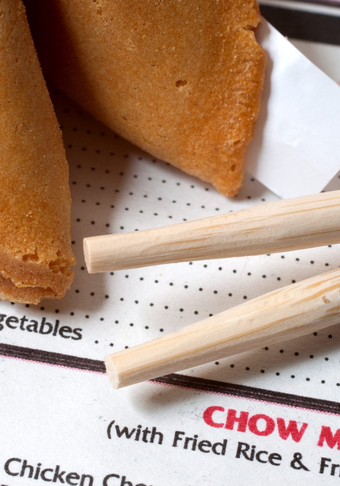 Chinese restaurant menu with chopsticks and fortune cookie.